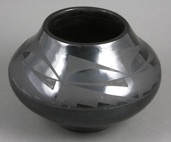 Tonita Roybal, San Ildefonso Blackware Pottery: 20th Century Native American San Ildefonso Pueblo, New Mexico black-on-black pottery jar, signed Tonita (Tonita Martinez Roybal, 1892-1945), 5"h. x 7 1/4"d. Good condition.