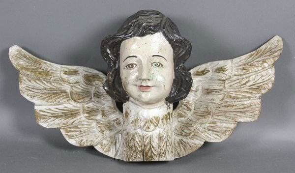 Carved Wooden Wall Hanging of an Angel: Carved wooden wall hanging of an angel with facial detail, realistic eyes and outstretched wings. 17"l. x 9"h.