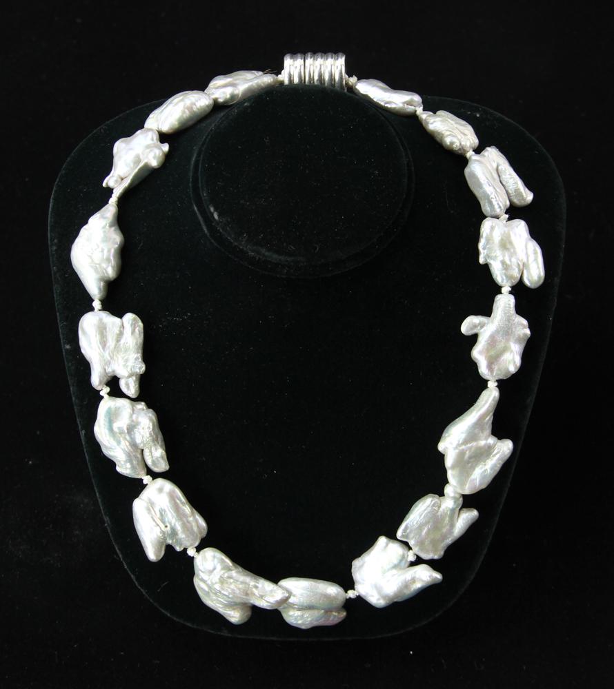 South Seas Keshi Pearl Necklace: South Seas Keshi pearl necklace, seventeen pearls, Baroque magnetic clasp, 18 " and 15mm-20mm (pearls). Provenance: South Hamilton, Massachusetts. PLEASE NOTE: payment for silver, gold, jewelry, and c
