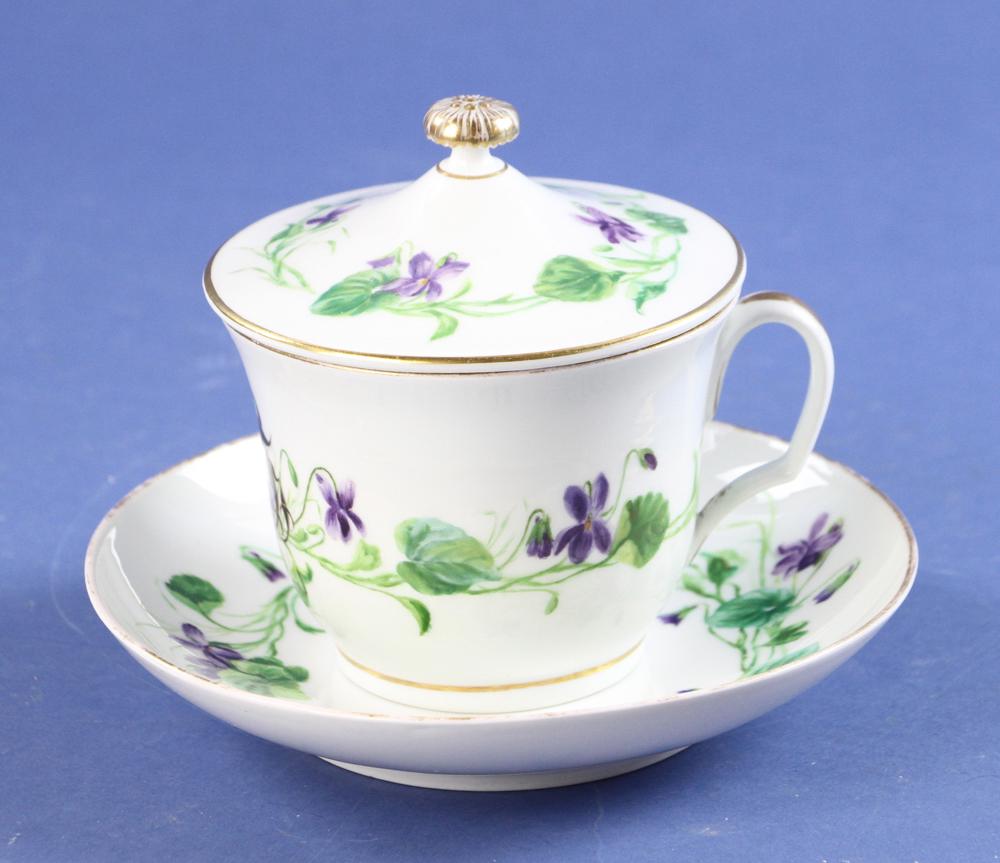 Meissen Covered Cup and Saucer: Meissen hand-painted porcelain covered cup with saucer, violet decoration, underglaze mark, saucer 6 1/2" diameter, cup 5" H, with cover. Provenance: Estate of Norma Szaro, Swampscott, MA.