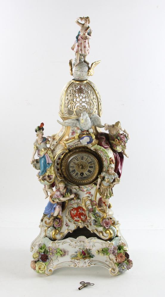19thC German Meissen Figural Clock on Stand: 19th century German Meissen figural clock on stand, includes key and pendulum, cross guard marks on base. 29" x 11 1/2" x 7 1/2" on stand.