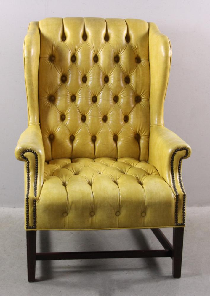 Yellow Vinyl Tufted Wing Chair: Yellow vinyl tufted wing chair. Provenance: From the estate of Gregory and Katherine Sullivan of Dover, MA.