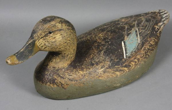 Black Duck Decoy by Ben Schmidt, Michigan: Black duck decoy by Ben Schmidt of Michigan, head turned slightly to the right, 6 5/8"h. x 15 3/4"w. Original paint shows average wear; slight overpaint to the lower sides; one eye missing.