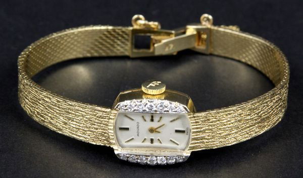 Ladies 14k Movado Diamond Wristwatch: Ladies 14k gold Movado wristwatch with (14) diamonds on the sides, 6". 0.66oz/12.4 dwt total weight.
