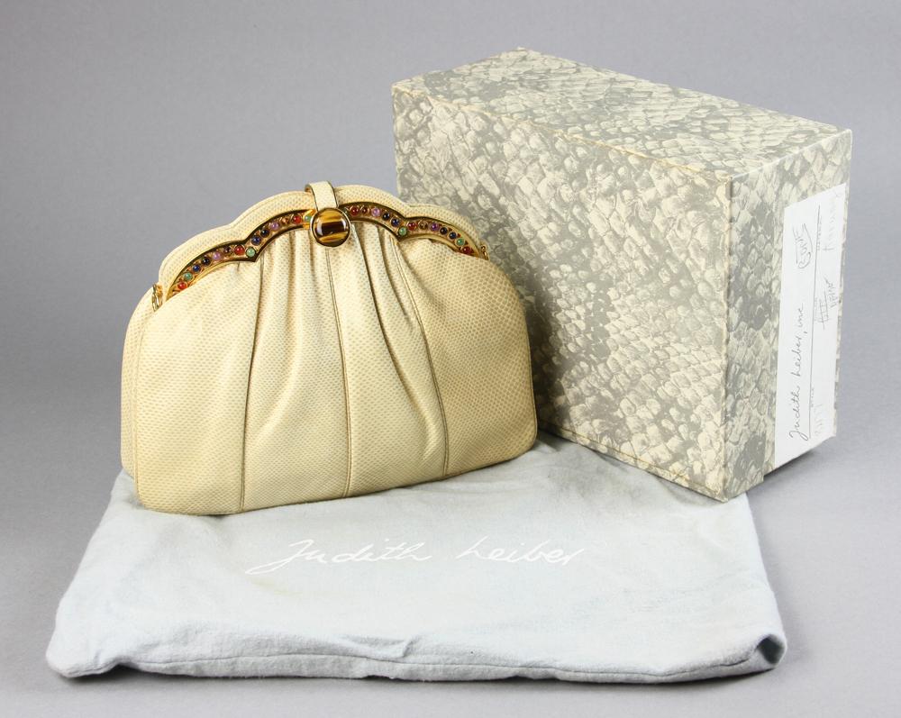 Judith Leiber Bone Color Reptile Handbag: Judith Leiber bone-color reptile handbag with inlaid stones, tiger eye clasp, 6 3/4" H x 8 3/4" W x 2" D. With original box.