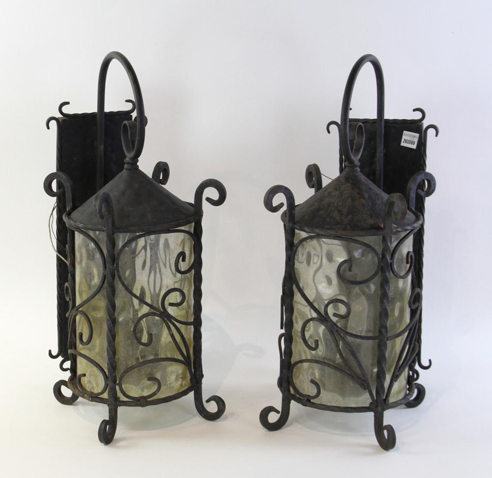 Pair of Wrought Iron Wall Lanterns: Pair of wrought iron wall lanterns. 23" H x 9" W x 12" D. Provenance: Other estates.