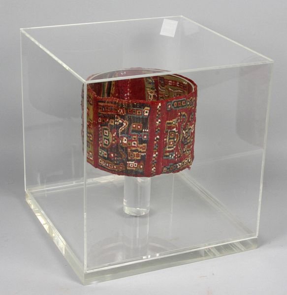 Pre-Columbian textile headpiece: Pre-Columbian textile headpiece with figural motif, Incan, 4" h. x 6" diam., 11" h. x 10 1/4" w. x 10 1/4" d. framed in plexiglas box.