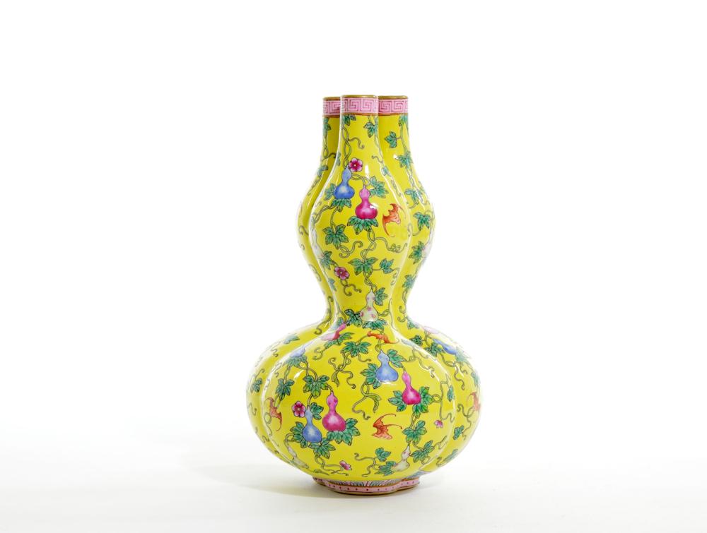 Rare and Fine Chinese Enamel Gourd Vase: Lobed gourd vase covered with rich yellow enamel decorated with vine leaves and various gourds, with bat flying around. Qianlong mark on base, 18th century. 8 1/2" H. Provenance: Private Estate Collec