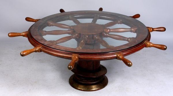 Ship's steering wheel & hub converted to table: 19th Century ship's steering wheel and hub converted to table with glass top, 18" h. x 52" diam (including wood spokes). Good condition.