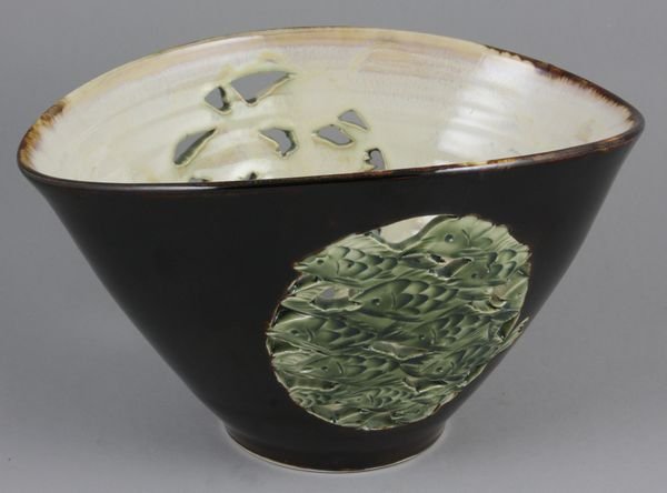 Oval brown glazed bowl w/green fish: Oval brown glazed bowl with pierced sides, decorated with green school of fish, 5 1/4" h. x 9 1/4" w. x 7" d., good condition. Provenance: Robert O. Peterson Estate, San Diego, CA.