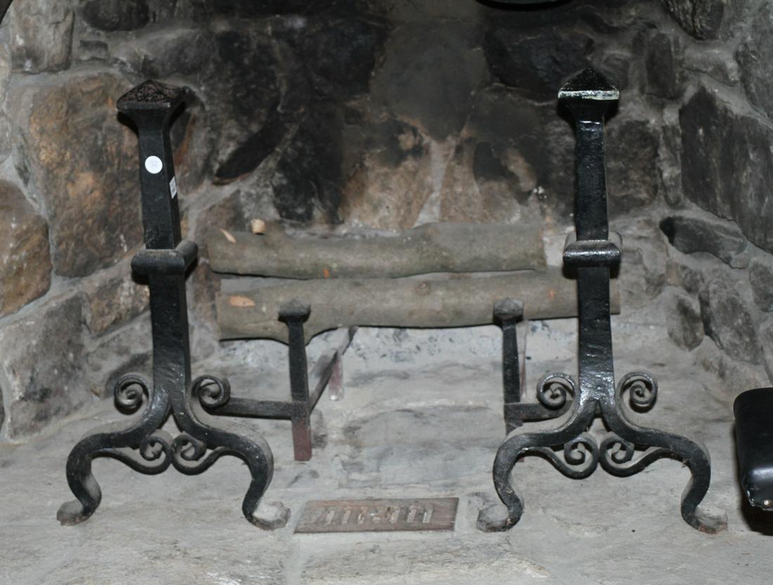 Pair of Heavy Wrought Iron Andirons: Pair of heavy wrought iron andirons, 26 1/2" H x 14 1/2" W (across base). Good condition. Provenance: Collection of Pat and Nathan Kornfeld, Verbank, New York.