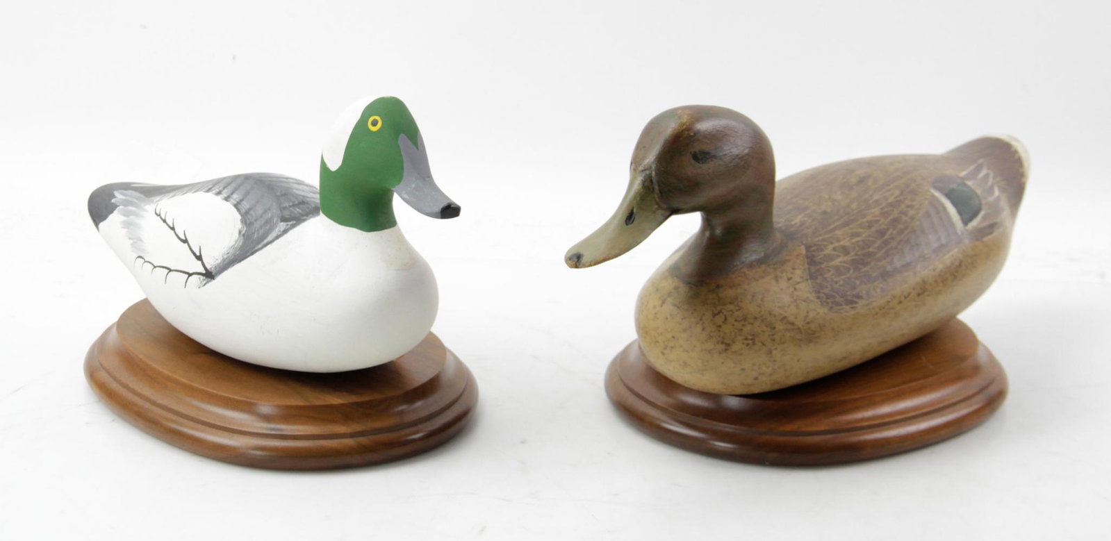 Hand Carved Hen Mallard and Bufflehead: Lot of (2) hand carved ducks, to include: a hen mallard signed "Madison Mitchell" and a bufflehead signed "Harry Jobes 1994; 16in and 12in long respectively. Provenance: Walnut Creek, California.