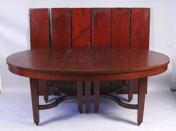 Hepplewhite-Style Mahogany Dining Table: Circa 1910 Hepplewhite-style oval mahogany dining table, with six leaves with stringing inlay, 31"h x 78" without leaves x 52", leaves are 11"w x 52"l, table is on casters, maker is probably Paine Fur