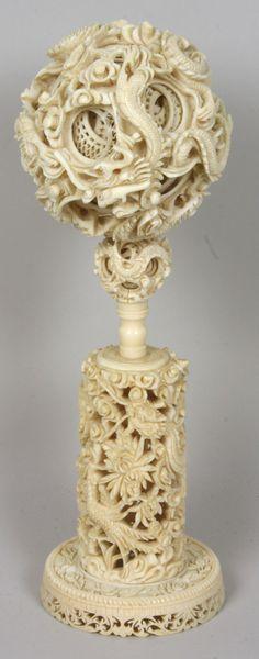 Early 20th C. Chinese Mystery Ball: Early 20th Century Chinese carved ivory mystery ball on carved ivory stand, ball is composed of thirteen (13) smaller balls. Exterior ball is composed of fish and dragons; interior balls feature open 