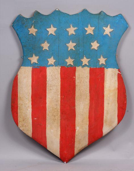 Folk Art U.S. Flag Shield: Folk Art U.S. flag shield decorated with paint, 31"h x 23 1/2"w x 1/2"d