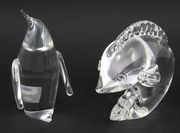 Two (2) Signed Steuben Crystal Ornaments: Two (2) signed Steuben crystal ornaments to include a leaping dolphin shape 7880 and a penguin shape 8080, tallest 6 1/4"h. Good condition.