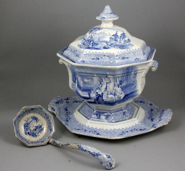19th C. Wedgwood Ironstone Tureen: 19th century Wedgwood ironstone Coloninna/Geneva pattern blue and white transfer tureen with cover, under plate, and ladle, 14"h x 14"w x 12"d. Old repair on ladle.