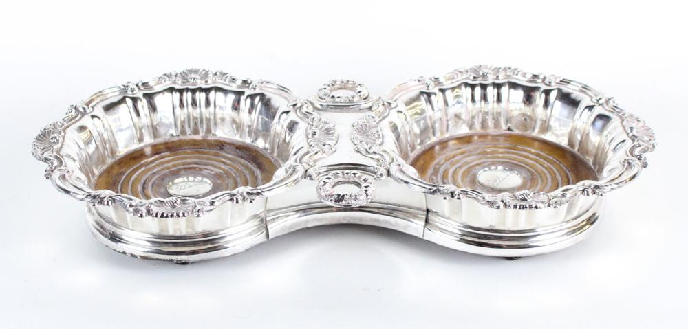 19thC English Silverplate Double Wine Coaster: 19th century English silverplate double wine coaster with wooden castors, has family crest, 2 1/2" H x 15" W x 7 1/4" D. Good condition. Provenance: Collection of Anthony Athanas, Pier 4 Restaurant, B
