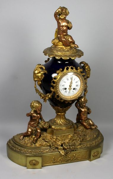 19th C. French Porcelain and Gilt Clock: 19th Century French porcelain and gilt clock with cherubs, 27 3/4" h. x 19 1/4" w. x 6" d. Provenance: Property of the late Robert O. Peterson, San Diego, CA.