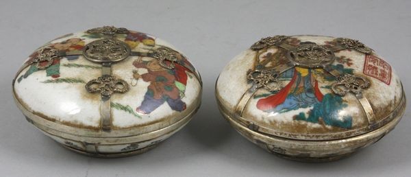 Pair of Qing Dynasty Cosmetic Boxes: Pair of Qing Dynasty Qianlong Period (1735-1796) cosmetic boxes of enamel with silver rosettes and ribbons, figural decoration on interior, marked on base and lids, 2"h x 4 1/4" dia. Even craquelure a