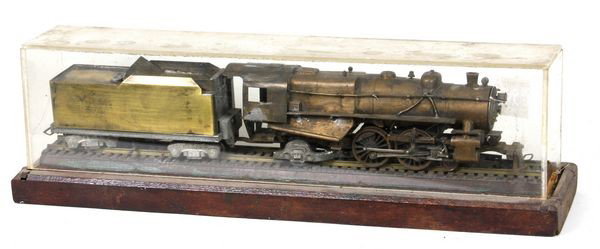 Model of a Steam Locomotive: Brass cased model of a steam locomotive and tender, case is 14"l. Fair condition, operational condition unknown.