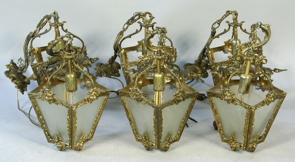 Set of Six (6) Four-sided Wall Sconces: Set of six (6) brass coated metal four (4) sided wall sconces, 22"l. Some glass panels missing. Provenance: From the 20th Century Props lighting collection in Hollywood, C.A.