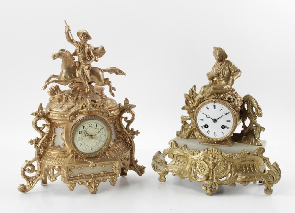 Two Figural Gold Painted Metal Clocks: Two figural clocks, gold-painted metal, one movement electrified, one 15 1/2" H x 11 1/2" W, the other 13" H x 11" W. Provenance: Estate of August van der Becq, Westport, Connecticut.