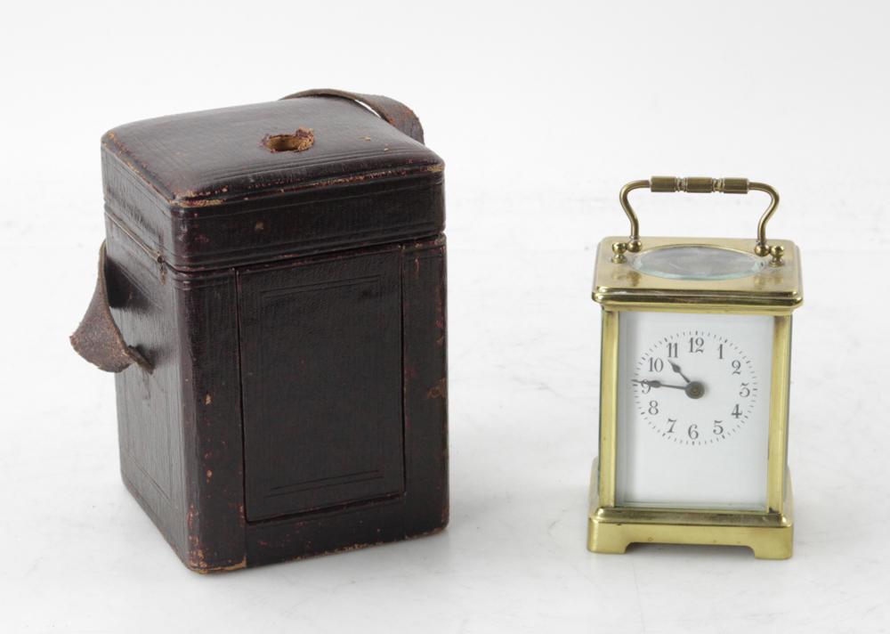 French Brass Carriage Clock with Case: French brass carriage clock in leather carrying case, 6 1/2" H x 4 1/2" W x 4" D. Provenance: Estate of August van der Becq, Westport, Connecticut.