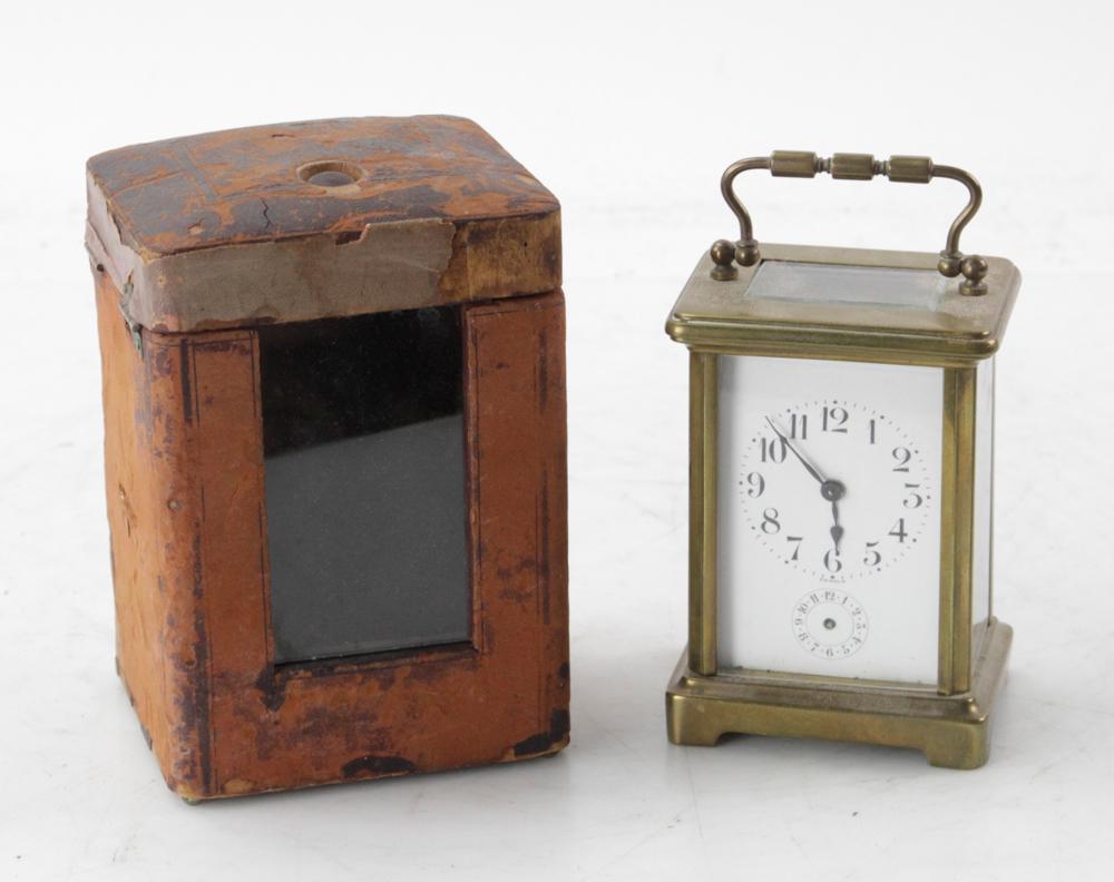 French Brass Carriage Clock, John Wanamaker: French brass and glass carriage clock in leather case, stamped on back John Wanamaker, Philadelphia, New York, 6" H x 4" W x 3 1/2" D. Provenance: Estate of August van der Becq, Westport, Connecticut.