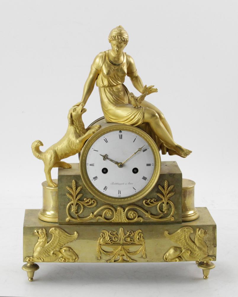 Early 19thC French Figural Clock, Balthazard: Early 19th century French figural clock, ormolu bronze, with young girl with dog, porcelain dial signed Balthazard, Paris, 16" H x 12" W x 4" D. Provenance: Estate of August van der Becq, Westport, Co