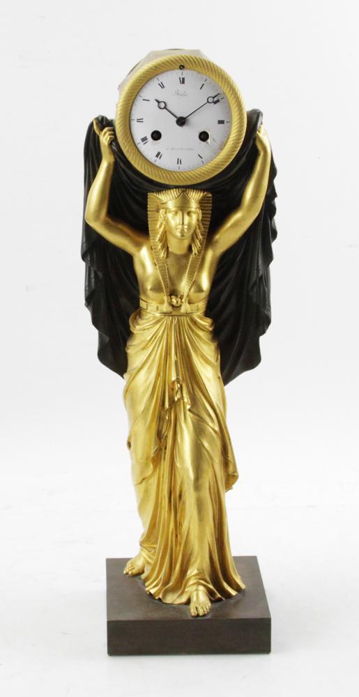 Early 19thC Bausse Egyptian Revival Bronze Clock: Early 19th century Egyptian Revival gilt bronze mantel clock by Pierre-Guillaume Bausse, Meridien Boulevard d'Antin, Paris, 21" H x 6" W x 7" D. Enamel dial has some chips. Provenance: Estate of Augus