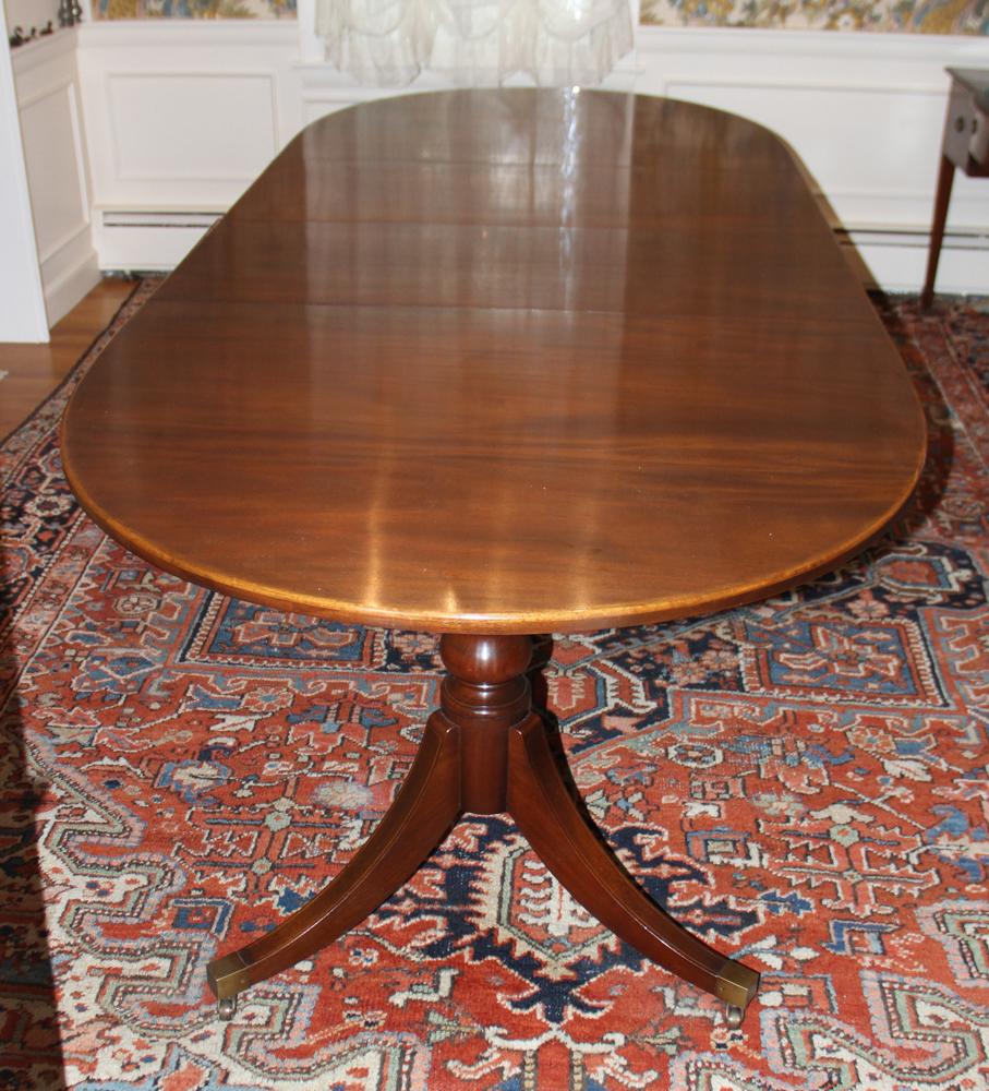 Early 20th Century Mahogany Dining Table: Early 20th century custom-made double pedestal dining table with Duncan Phyfe bases, two leaves, 29 1/2" H x 68" L x 44" W, leaves measures 18" L. Good condition. Provenance: Lifetime collection of Ja