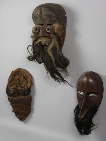 Three (3) African Masks: Lot of three (3) African masks, some with hair and straw attachments, 10"h x 7"w x 5"d. Good condition; some signs of wear. Provenance: purchased in Africa during the 1960/70s.