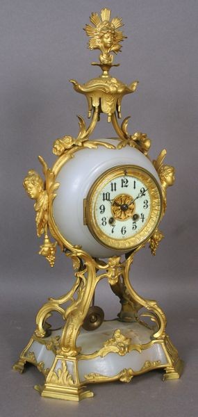 19th C. French Marble Clock: 19th Century French marble and ormolu clock with porcelain face, signed indistinctly on movement, 16 1/4"h. Good condition.