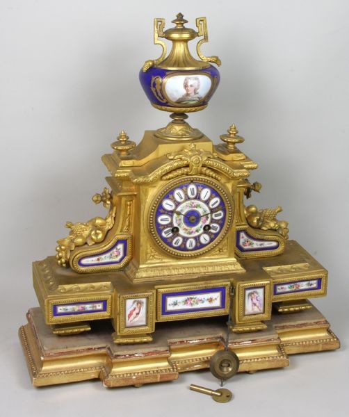 19th C. Louis XIV Clock: 19th Century Louis XIV gilt metal and ormolu clock with Sèvres porcelain panels, signed "J. Masti", with key and pendulum, 16"h x 15"w x 6"d.