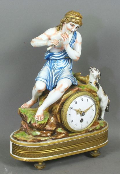 Mid 19th C. Italian Porcelain Clock: Mid 19th Century Italian porcelain clock having a flute player with a dog figure, marked on bottom "Capo di Monte", 10 1/4"h. x 8 1/4"w. x 3 3/4"d. Old restoration, no key.