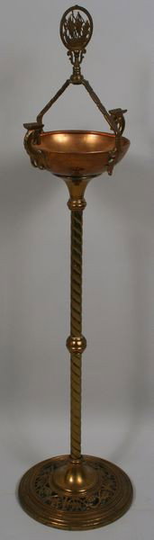 Oscan B. Bach C. 1920's Floor Ash Tray: Oscan B. Bach floor ash tray, circa 1920's, brass and copper, ship finial on handle, seahorse rests, pierced base, signed on bottom, 39"h x 10"w. No damage to note.