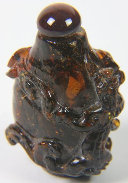 Amber Snuff Bottle: Amber Snuff Bottle, China, 19th century, of pear form carved with two chi dragons and clouds, 1 1/2" high.