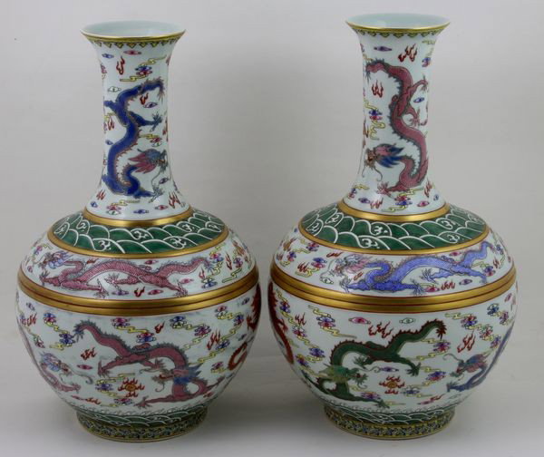 Pair of Porcelain Dragon Vases: Pair of Porcelain Dragon Vases, China, with dragons amid clouds, Guangxu mark on base, 16" high x 9 1/2" wide.
