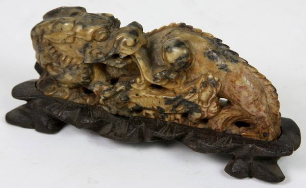 Carved Soapstone Dragon: Carved Soapstone Dragon, China, 19th century, attending to the pearl ball, with custom fit black soapstone stand, signed on bottom, 2" high x 4 1/2" wide.