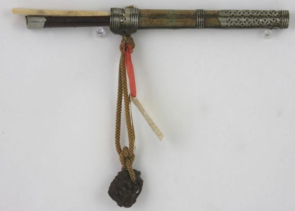 Mongolian Knife: Mongolian Knife, China, 19th century, wrapped with snake skin and pierced silver on the top and end, accompanied by ivory chopsticks and a wooden dragon toggle marked on base, knife is 10" long.