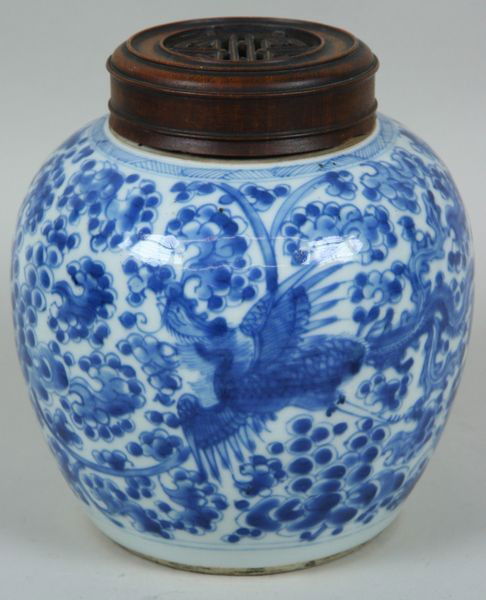Blue and White Porcelain Jar: Blue and White Porcelain Jar, China, 19th century, painted with a pheonix, carved wood cover, double ring mark on base, 7 1/2" high x 6" diameter, undamaged.