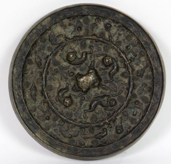 Bronze Mirror: Bronze Mirror, China, Han Dynasty (206 BC - 220 AD), with monkey and floral motif on back, 4 3/4" diameter, undamaged.