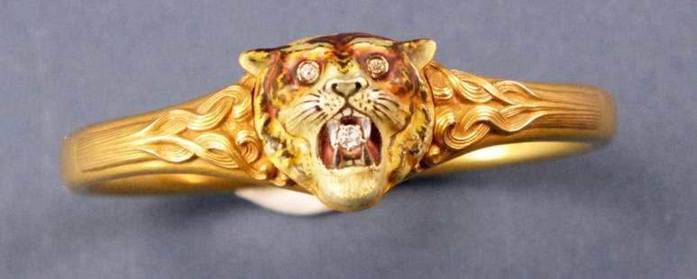 10k Gold and Diamond Bracelet with Tiger Head: 10k yellow gold and diamond bracelet, having tiger head with diamond eyes, approximately 1/32 ct each, and diamond in mouth, approximately 1/8 ct. Inside diameter 2 1/2" x 2". Approximately 21 grams