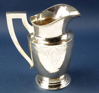 Sterling Engraved Water Pitcher: Sterling water pitcher having engraved decoration, monogrammed on side "EKR", 9 1/2" H x 8 1/2". Approximately 23.5 troy oz. Provenance: Furnishings from the Park Avenue home of a New York socialite.