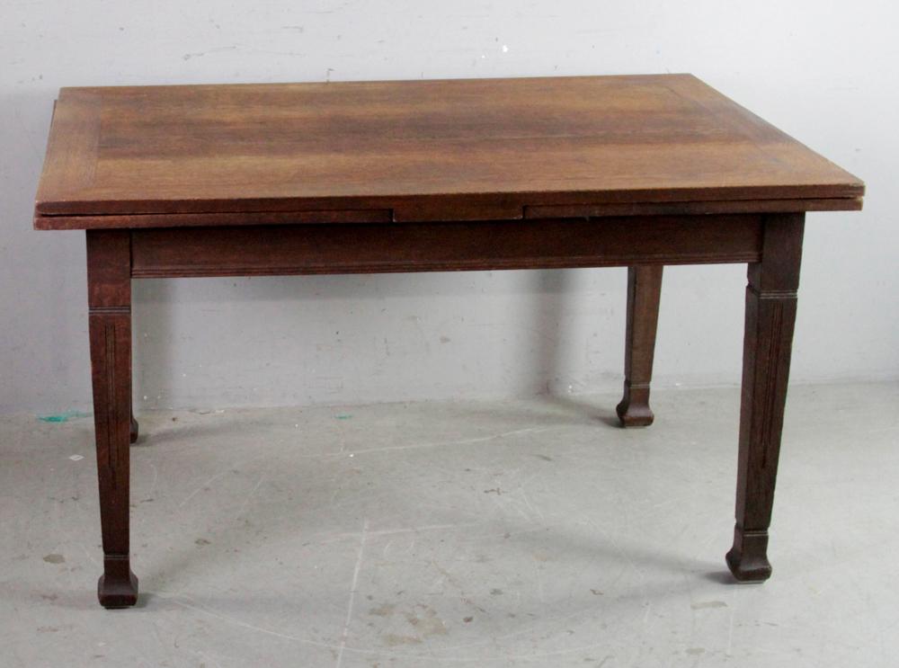 Mission Oak Dining Table: Mission oak dining table with sliding leaves at each end, 31" H x 55" W x 39" D, each leaf 23 1/4". Some staining and finish wear, repair on one leg at upper corner, otherwise good condition. Provenan