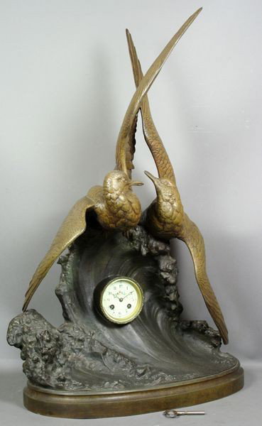 Auguste Lechesne, Sculptural Clock : Auguste Lechesne (French, c.1815-1888), bronzed white metal sculpture of two birds riding the waves and featuring a hand painted porcelain dial clock in middle, signed "A. Lechesne" on base, having Fr