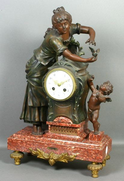 19th C. French Figural Mantle Clock: 19th Century French bronzed white metal figural mantle clock on a marble base with ormolu leaf design feet, figure signed "La Protection Par Moreau Sculpt", 21"h. x 13"w. x 5 1/2"d. Good condition.