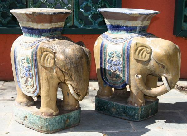 Two Elephant-Form Pedestals: Two elephant-form glazed pedestals, 23" high x 19 1/2" deep x 10" wide, weathered, and three old repairs on top of one.