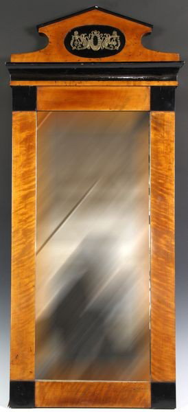 Biedermeier Mirror: Biedermeier mirror, ebonized and satinwood with gilt brass medallion at top, 36"h x 16"w. Some old worm damage.